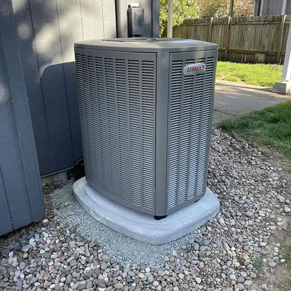 New Lennox air conditioner installed outside a grey home.