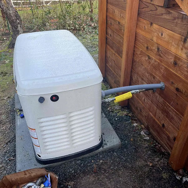 Air conditioning system outside a log home on a rainy day.