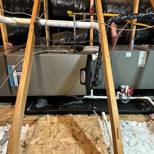 Air handler laying horizontally in an attic.