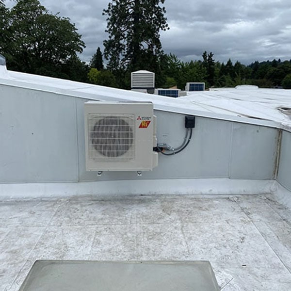 A newly installed Mitsubishi HVAC system on the roof of a commercial building.