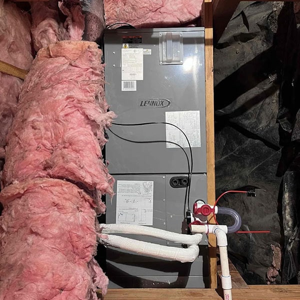 HVAC unit surrounded by new insulation work.