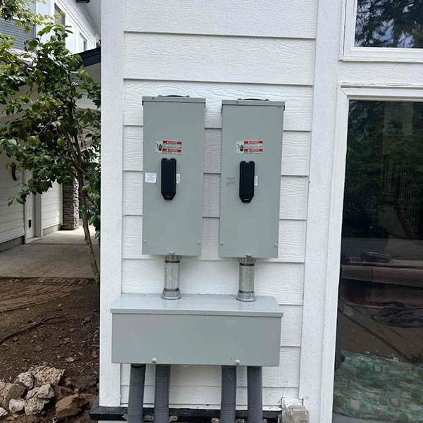 Electrical vehicle charging station installed outside a home.