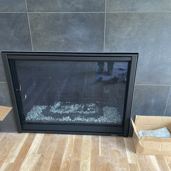 A newly installed gas fireplace in a home.