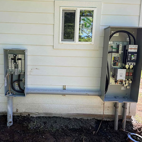 An electrical circuit on the wall outside a home.