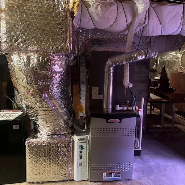 HVAC system and duct work set up in a clean and organized attic.