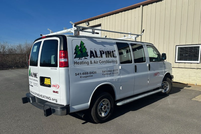 Alpine HVAC work vehicle parked outside the company shop.