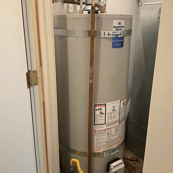 Water heater in the water heater closet of a home.