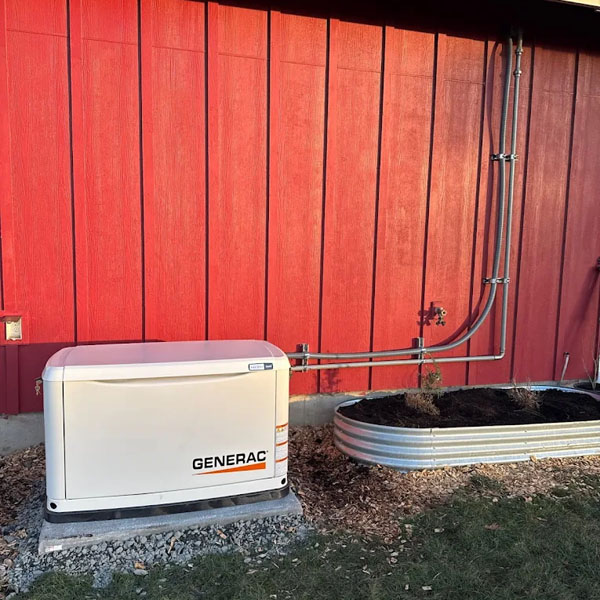 A new Generac generator installed outside of a red home.